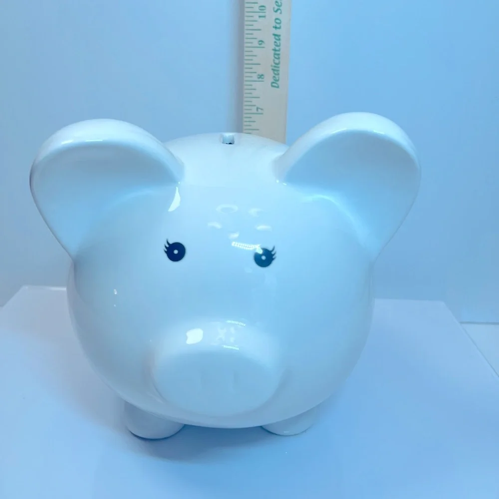 White Ceramic Piggy Bank with Pink and Purple Floral and Butterfly Designs.